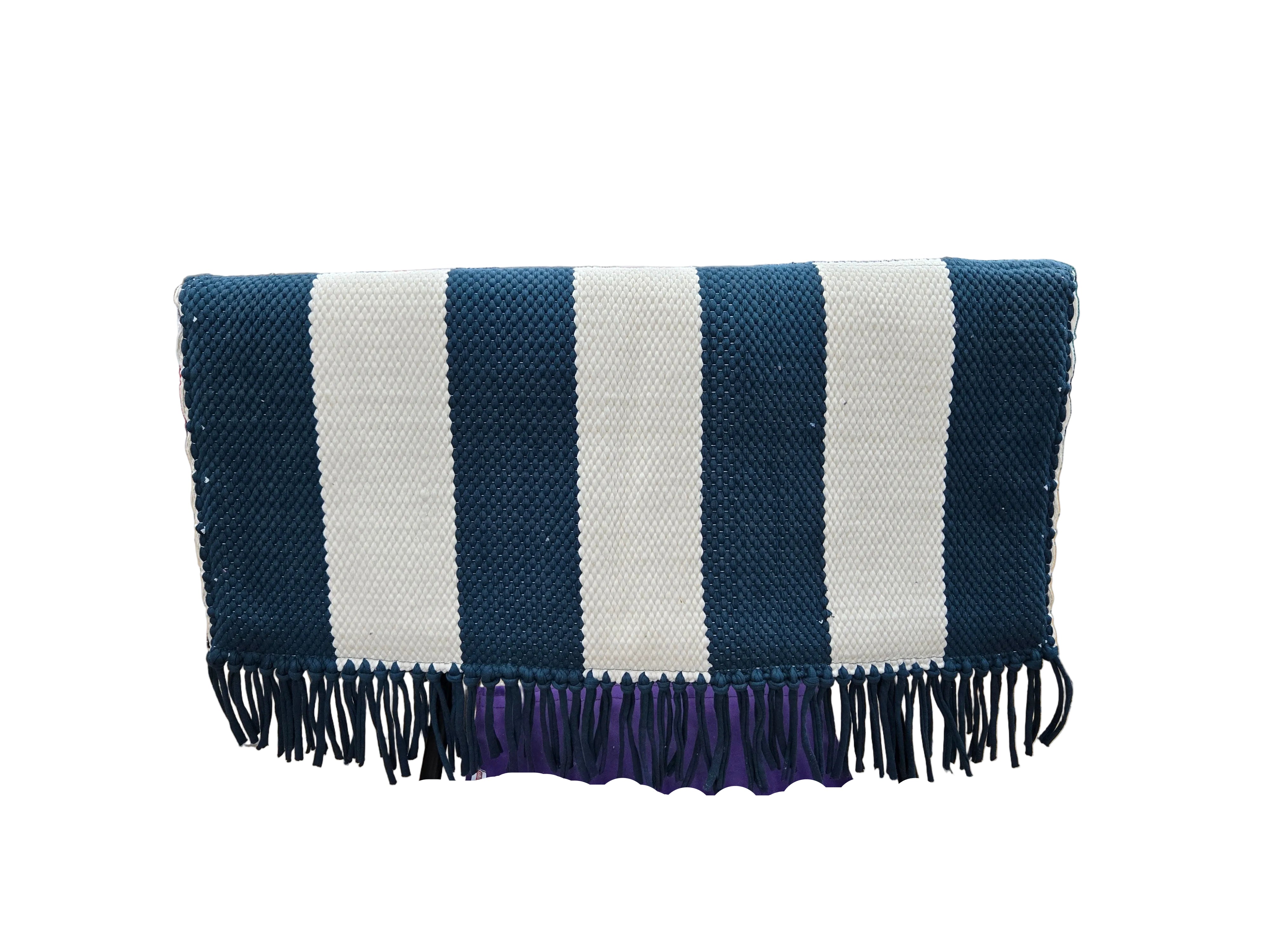 Striped blue and white blanket with fringes on a stand in a warehouse setting